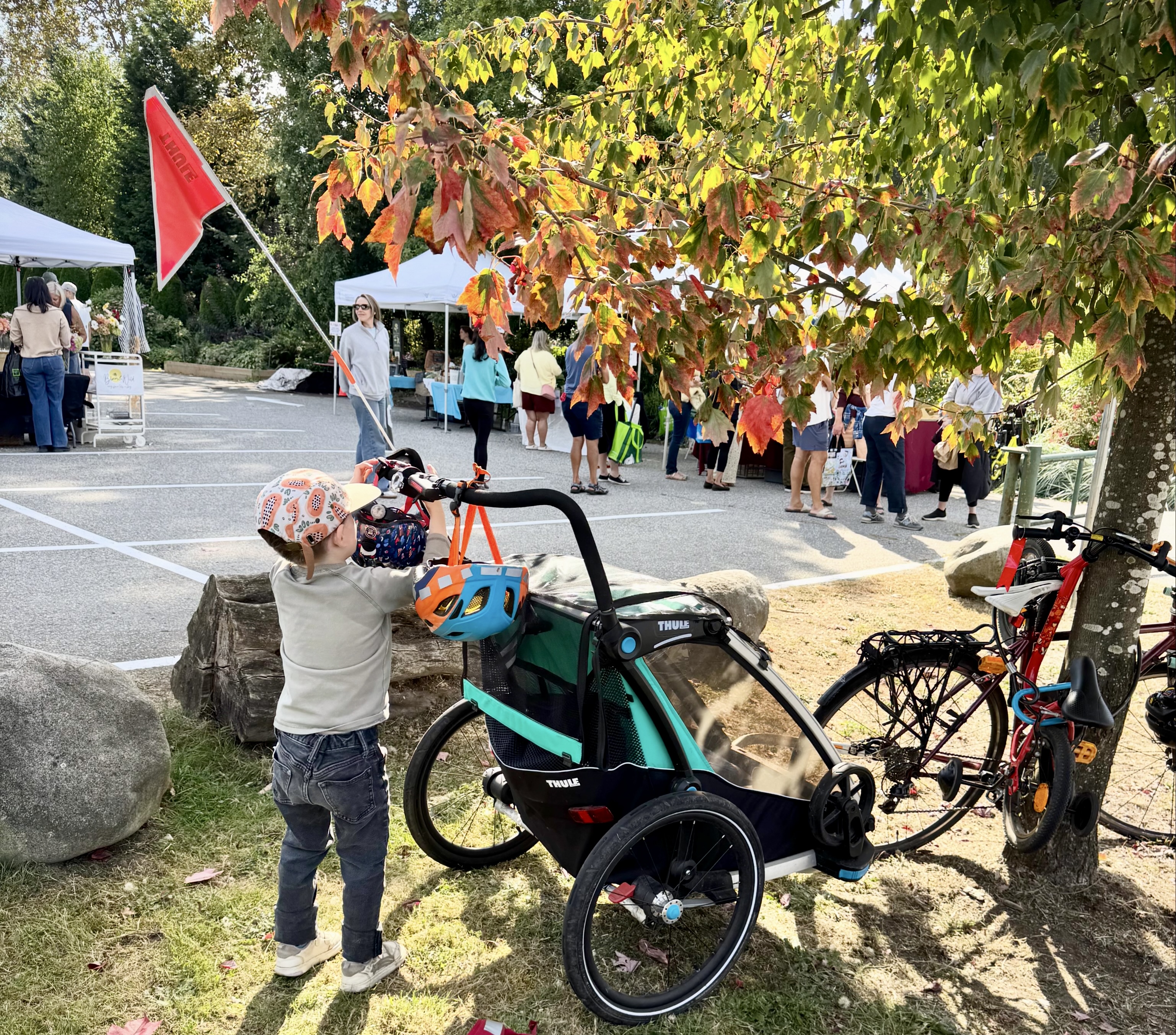 Child next to a bike trailer at Loutet Farmers Market